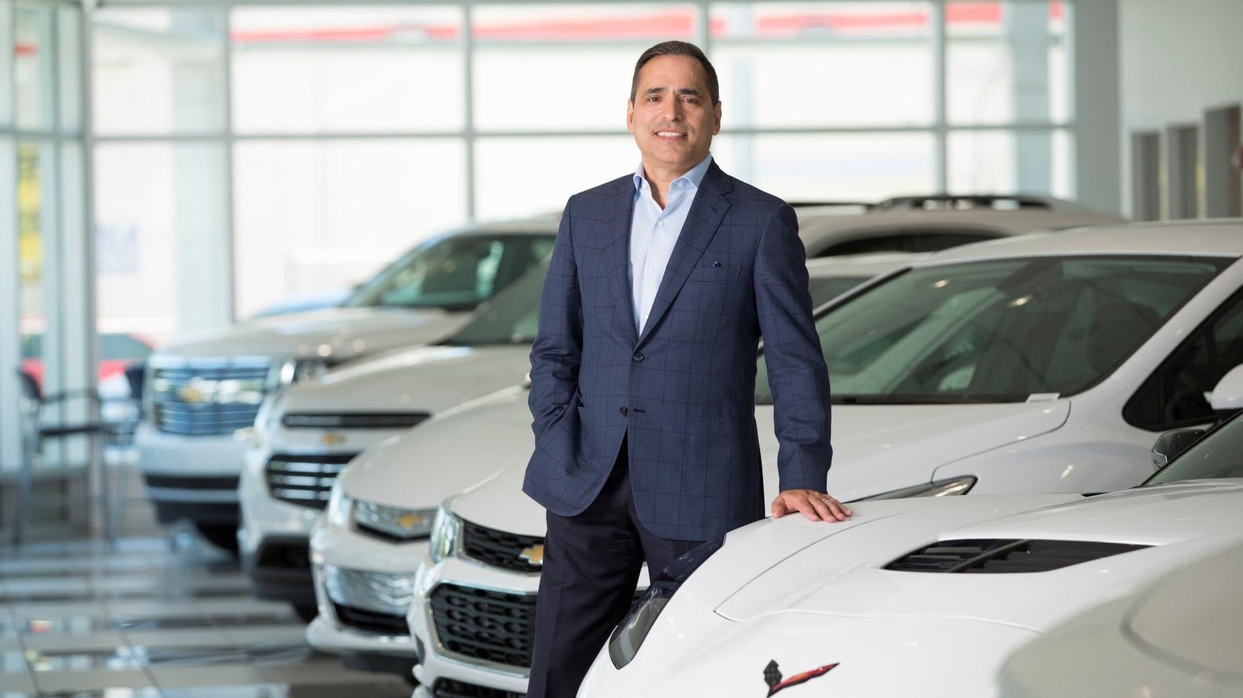 Owner standing by car Bomnin Chevrolet Nanuet in Nanuet NY